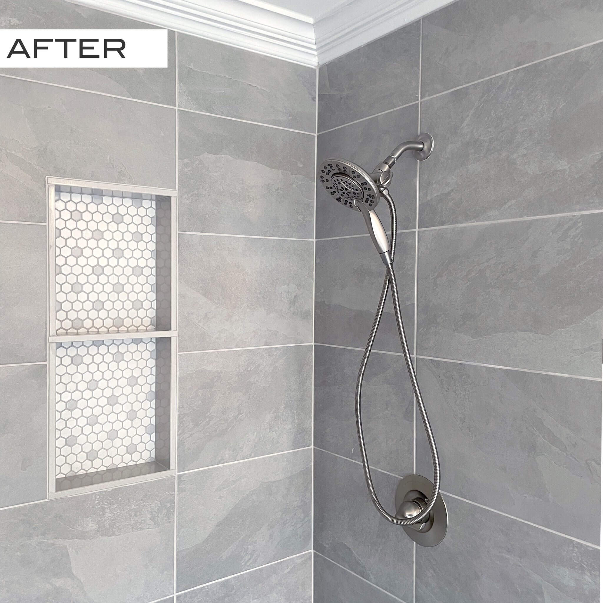 Modern shower with gray tiles and recessed decorative niches.